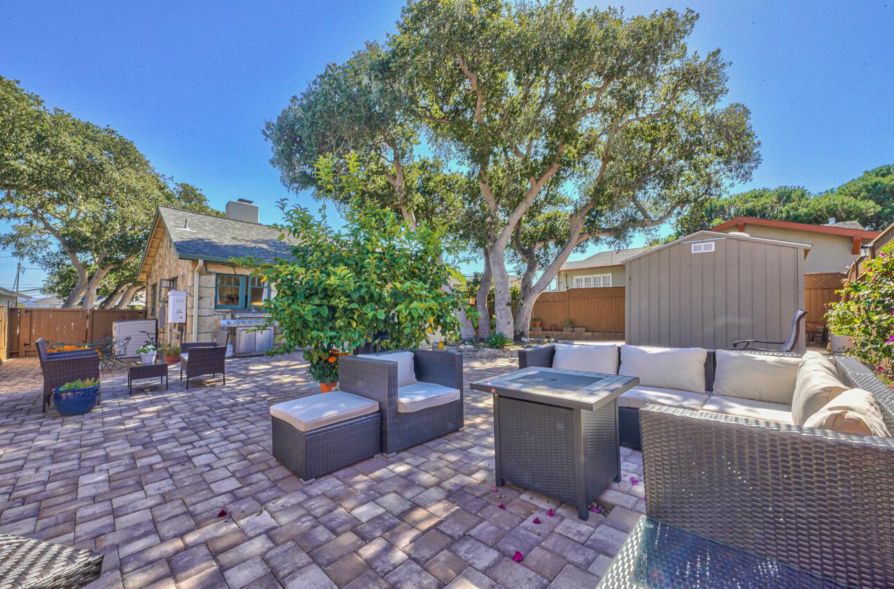 324 Eardley Avenue Pacific Grove, CA 93950 - Photo 27 of 29 a view of a patio with table and chairs under an umbrella