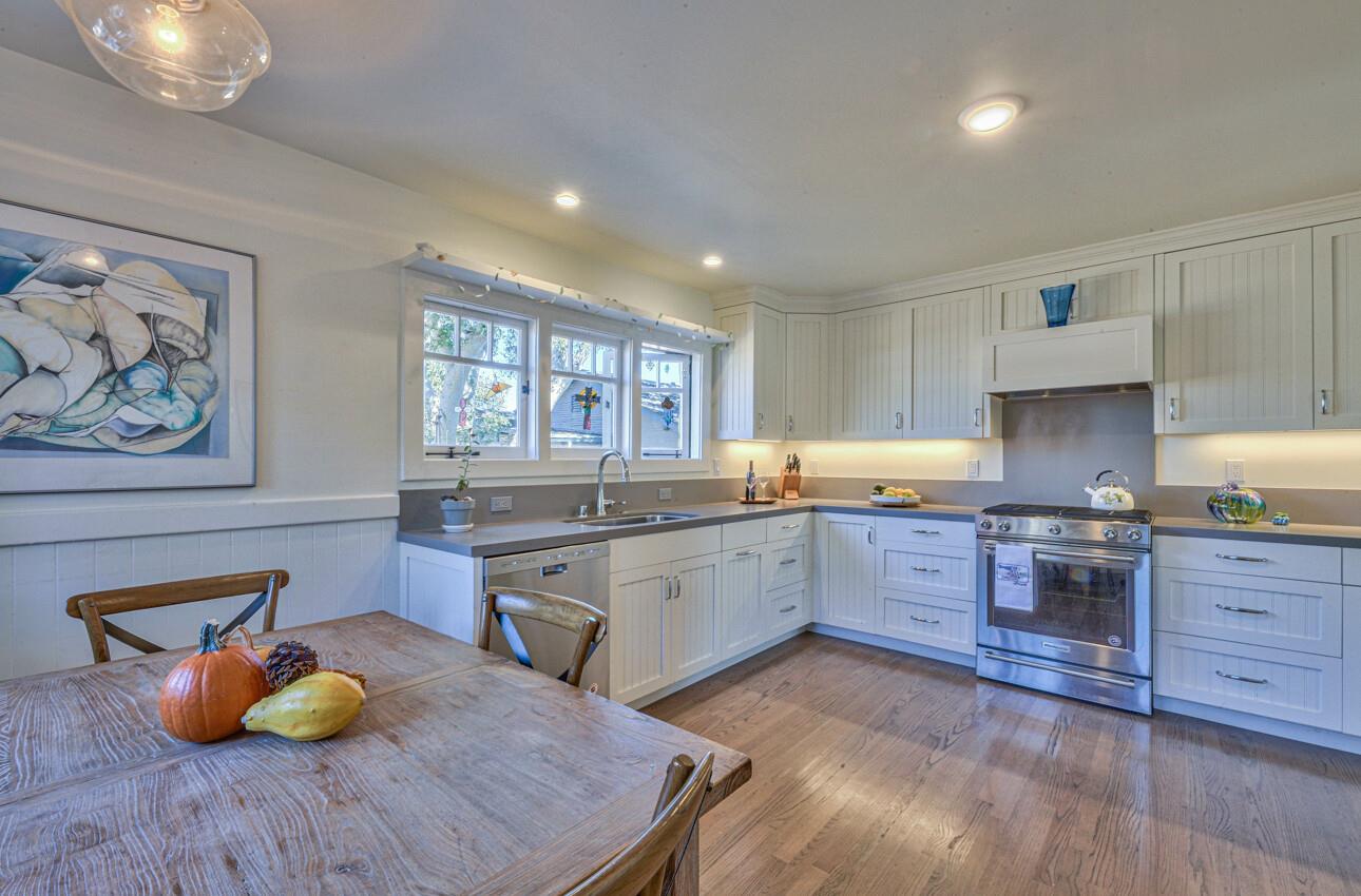 324 Eardley Avenue Pacific Grove, CA 93950 - Photo 9 of 29 a kitchen with stainless steel appliances granite countertop a sink dishwasher stove and wooden cabinets