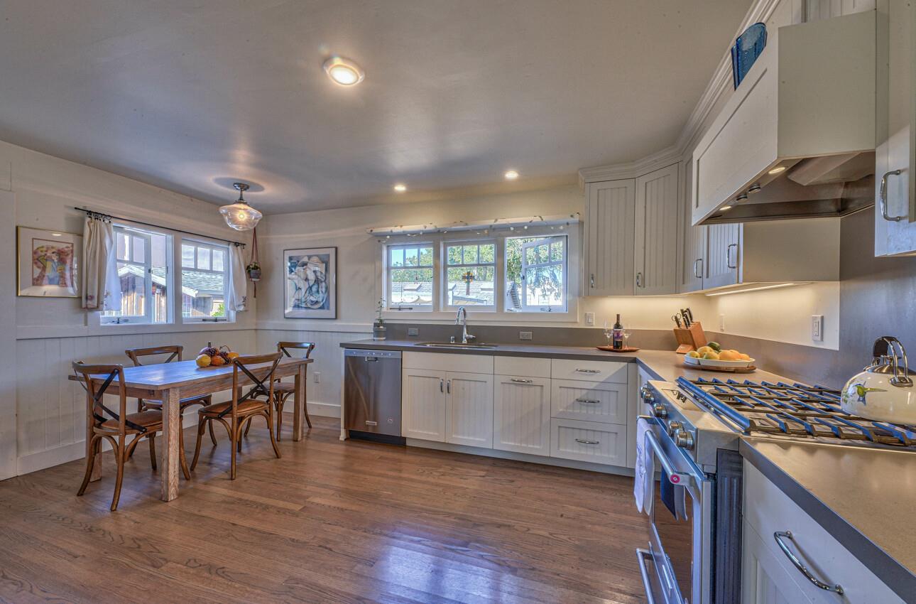 324 Eardley Avenue Pacific Grove, CA 93950 - Photo 10 of 29 a kitchen with lots of counter top space and dining table