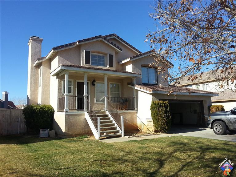 37033 Boxleaf Road Palmdale, CA 93550 - Photo 1 of 15 a view of a house with a yard and a car parked in front of it