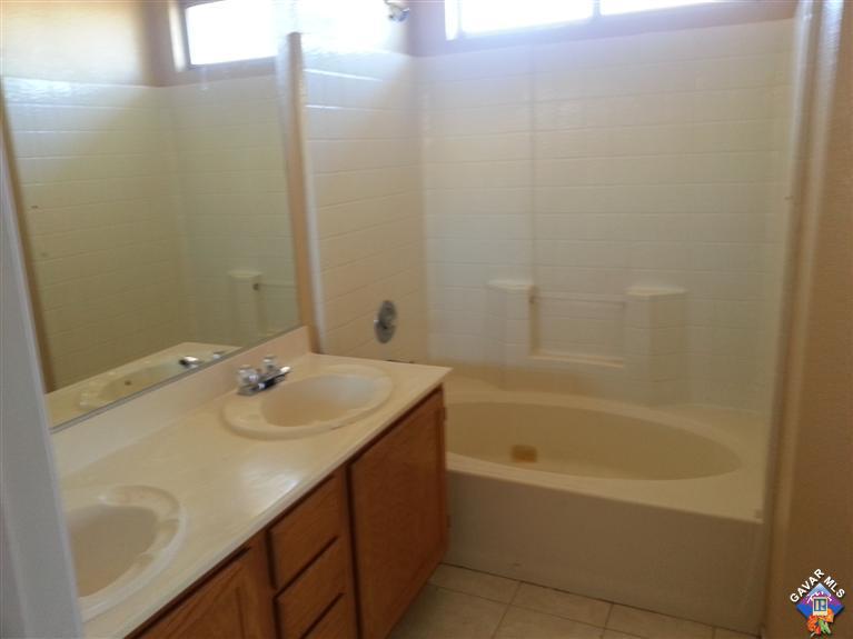 37033 Boxleaf Road Palmdale, CA 93550 - Photo 11 of 15 a bathroom with a sink and a bathtub