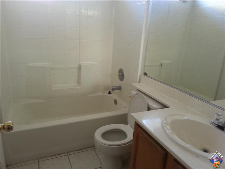 37033 Boxleaf Road Palmdale, CA 93550 - Photo 12 of 15 a bathroom with a sink a toilet and bathtub