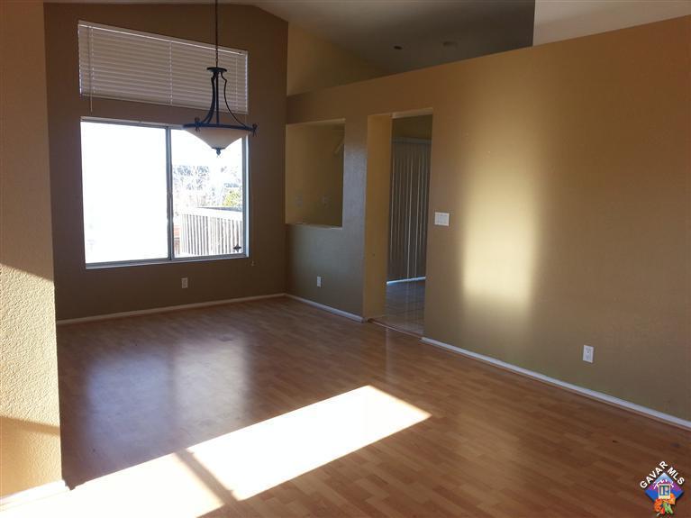 37033 Boxleaf Road Palmdale, CA 93550 - Photo 5 of 15 an empty room with wooden floor and windows