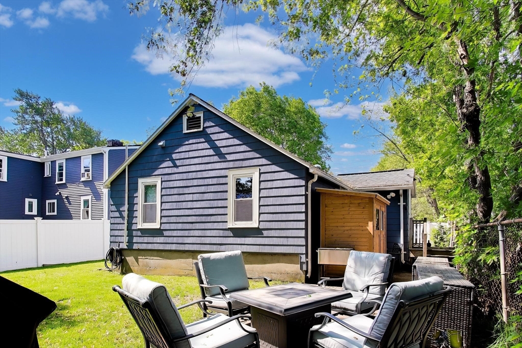 22 Douglas Road Ashland, MA 01721 - Photo 22 of 24 a backyard of a house with outdoor seating