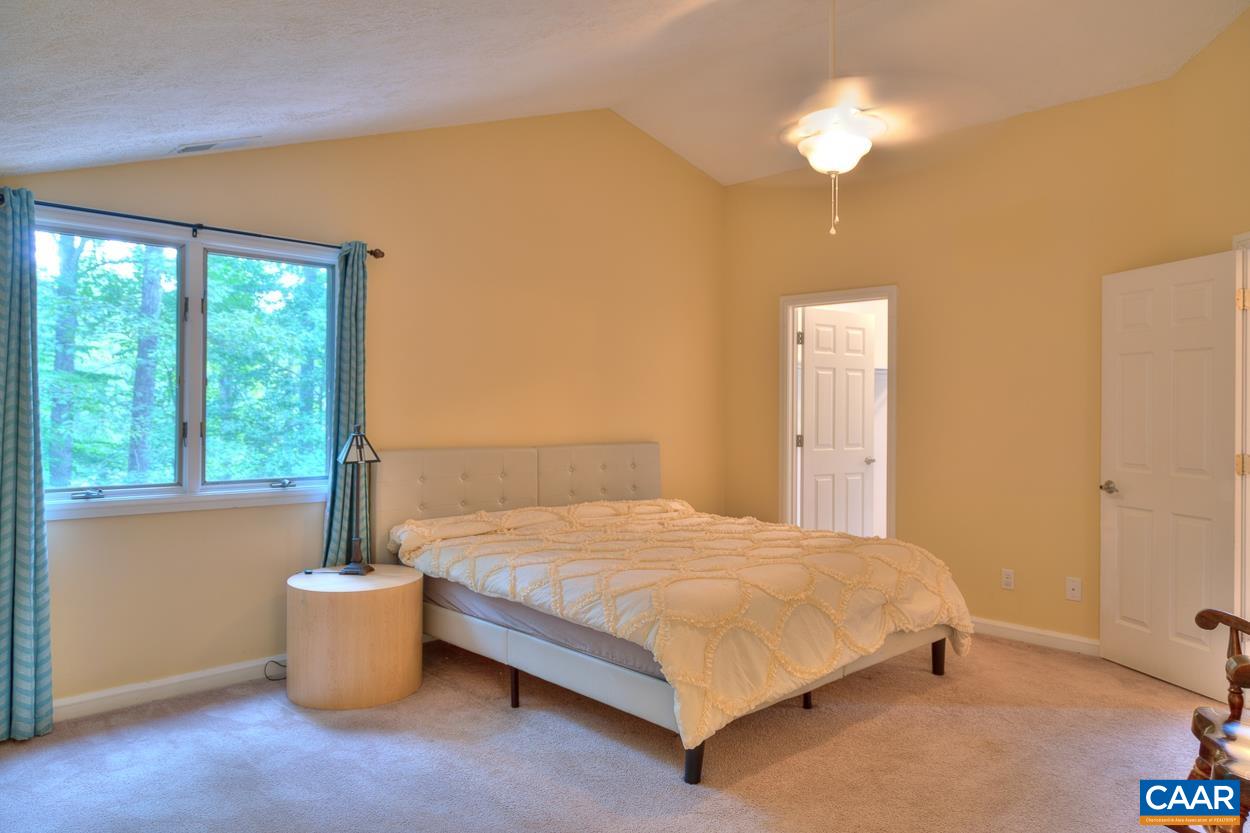7 Stonewall Road Palmyra, VA 22963 - Photo 25 of 55 a bedroom with a bed and a chandelier