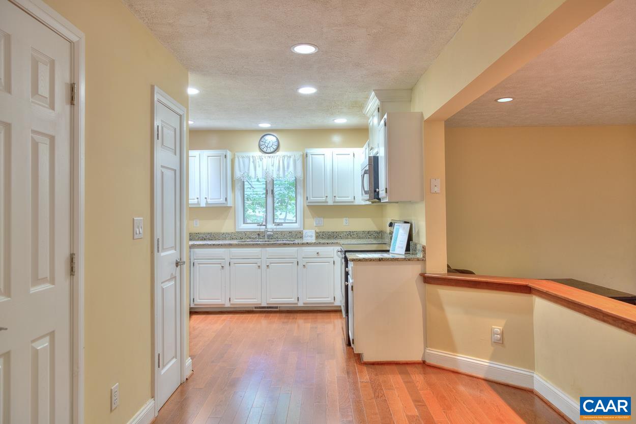 7 Stonewall Road Palmyra, VA 22963 - Photo 9 of 55 a kitchen with granite countertop white cabinets and wooden floor