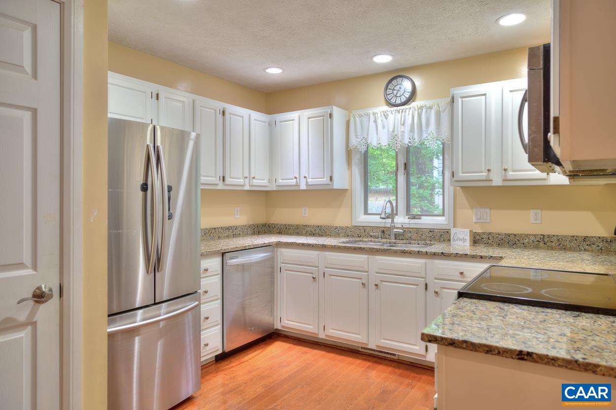 7 Stonewall Road Palmyra, VA 22963 - Photo 10 of 55 a kitchen with stainless steel appliances granite countertop a refrigerator a sink dishwasher a stove and white countertops with wooden floor