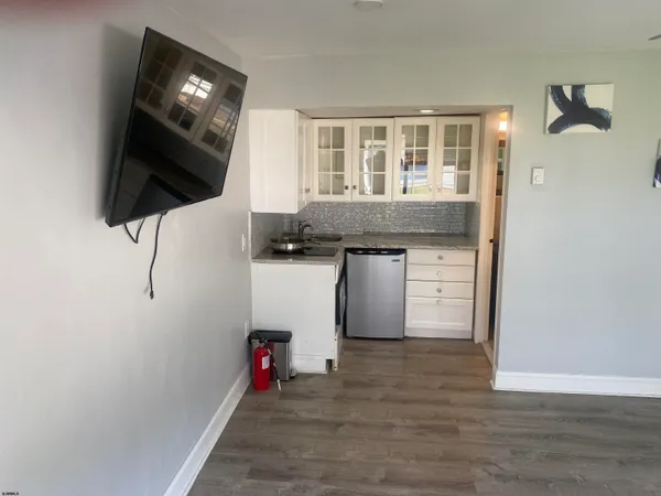 a view of a livingroom with an empty space and a window