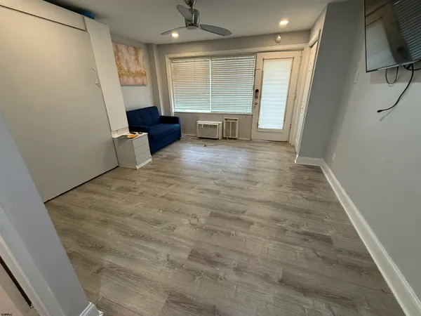 a living room with furniture and a walk in closet