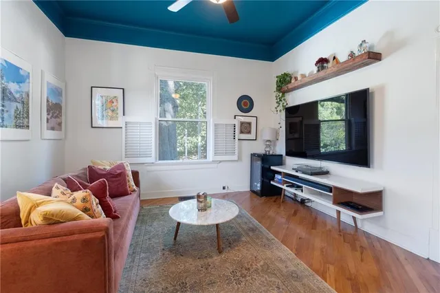 a living room with furniture window and flat screen tv