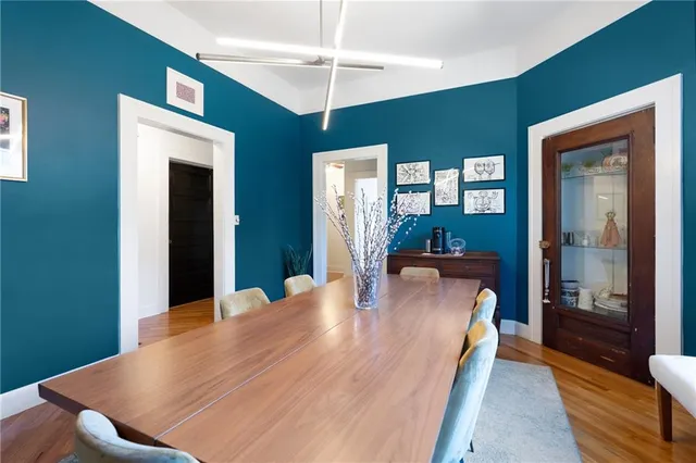 a dining room with a wooden table and chairs