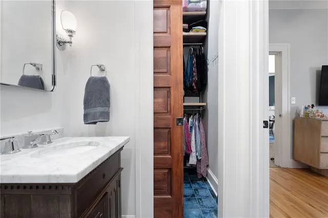 a bathroom with a granite countertop toilet a sink and a mirror