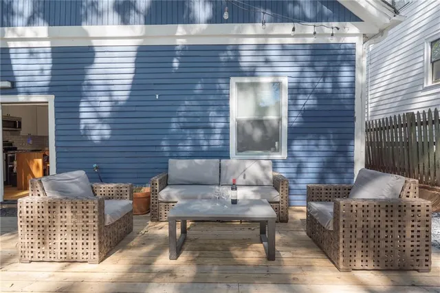 a view of backyard with outdoor seating and trees