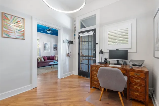 a livingroom with workspace and a window