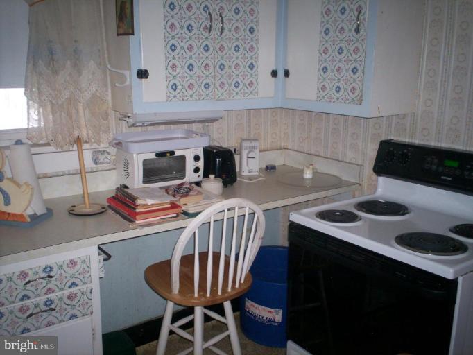 2195 Clary Road Strasburg, VA 22657 - Photo 6 of 8 a kitchen with a sink a stove and a table