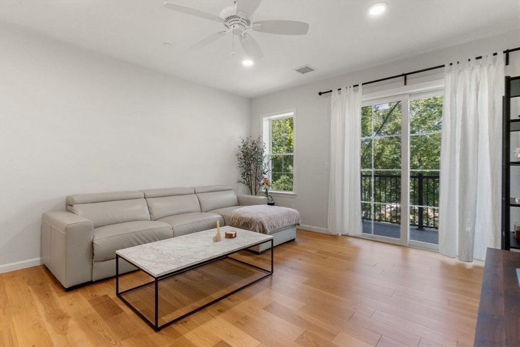 a living room with furniture and wooden floor