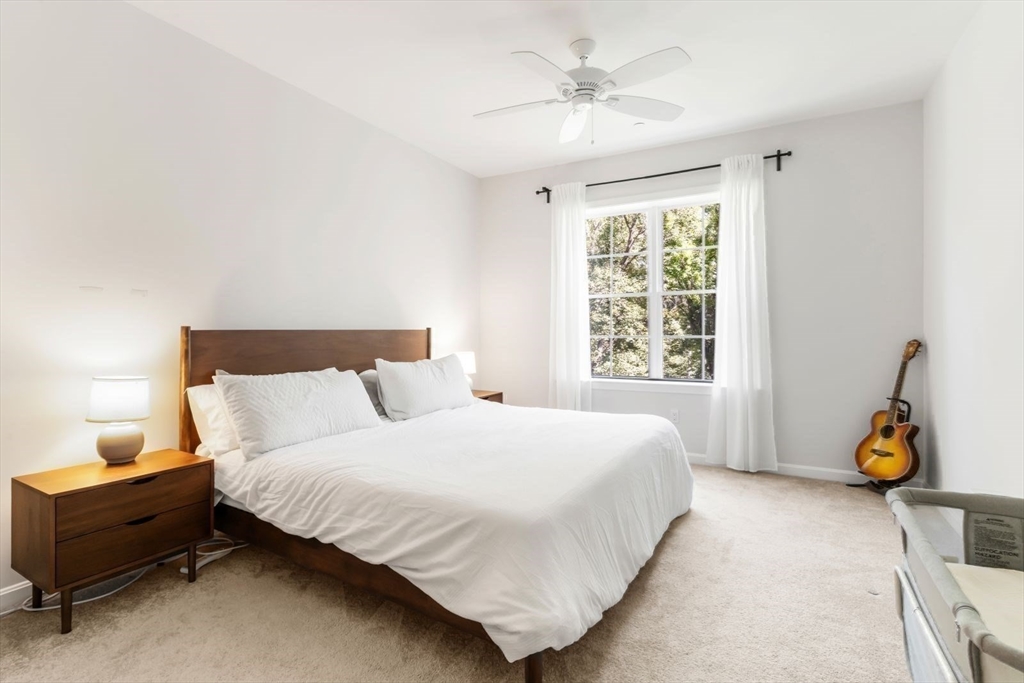 60 Coppersmith Way, Unit 304 Canton, MA 02021 - Photo 12 of 42 a bedroom with a bed and window