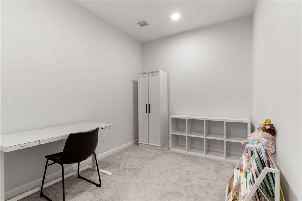 60 Coppersmith Way, Unit 304 Canton, MA 02021 - Photo 13 of 42 a view of a workspace with furniture and closet