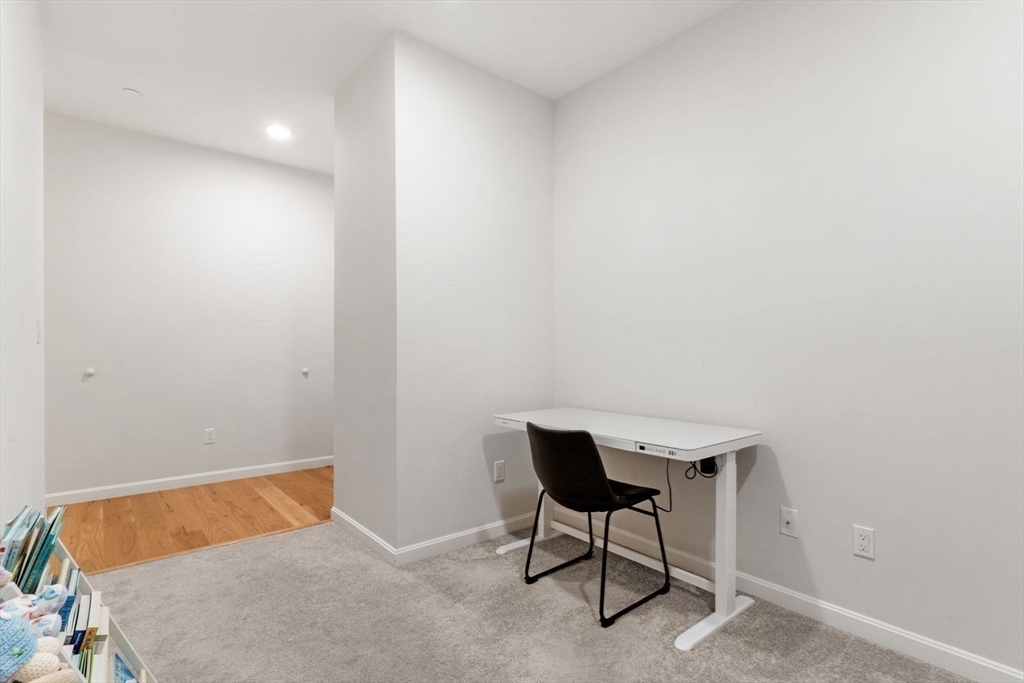 60 Coppersmith Way, Unit 304 Canton, MA 02021 - Photo 14 of 42 a bedroom with a bed and a table in it