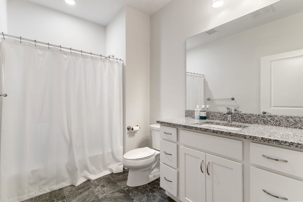 60 Coppersmith Way, Unit 304 Canton, MA 02021 - Photo 17 of 42 a bathroom with a granite countertop sink toilet and shower