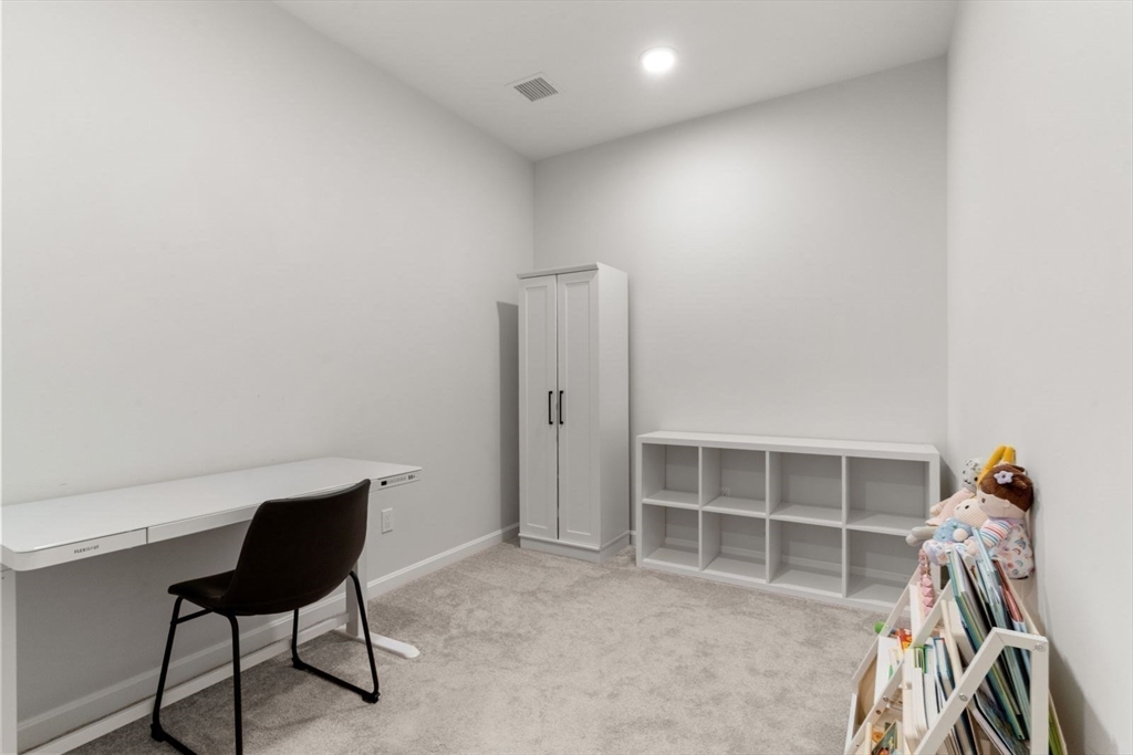 60 Coppersmith Way, Unit 304 Canton, MA 02021 - Photo 18 of 42 a view of a workspace with furniture and closet