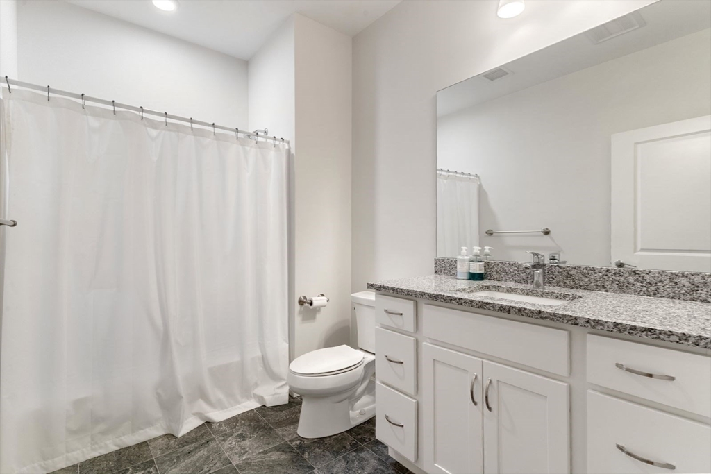 60 Coppersmith Way, Unit 304 Canton, MA 02021 - Photo 19 of 42 a bathroom with a granite countertop sink toilet and shower