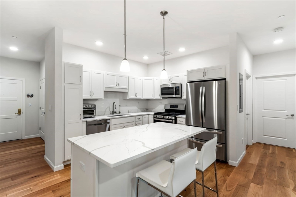 60 Coppersmith Way, Unit 304 Canton, MA 02021 - Photo 2 of 42 a kitchen with stainless steel appliances a refrigerator a stove a sink and white cabinets