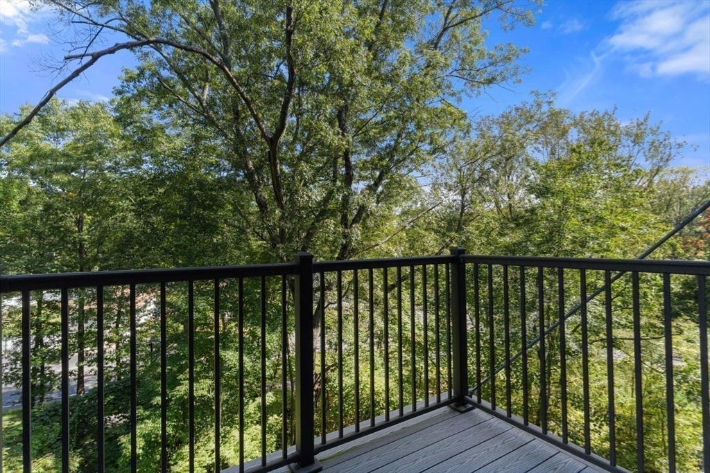 60 Coppersmith Way, Unit 304 Canton, MA 02021 - Photo 21 of 42 a balcony with wooden floor and outdoor space