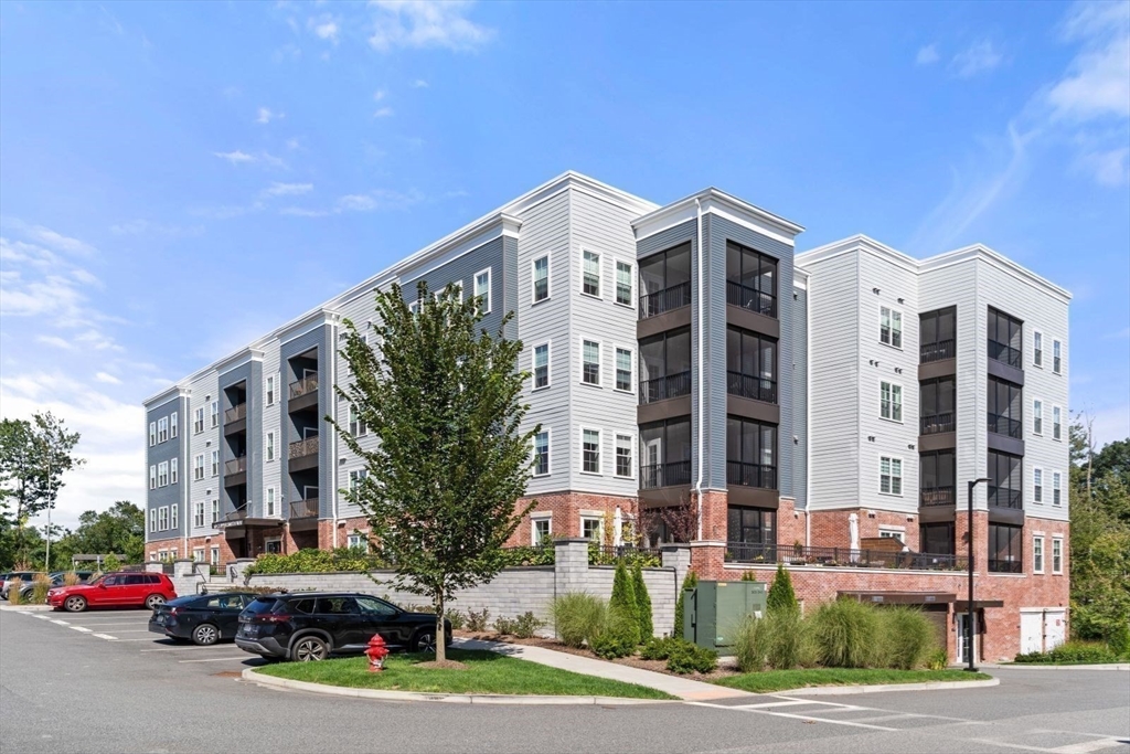 60 Coppersmith Way, Unit 304 Canton, MA 02021 - Photo 30 of 42 a city street lined with buildings and cars