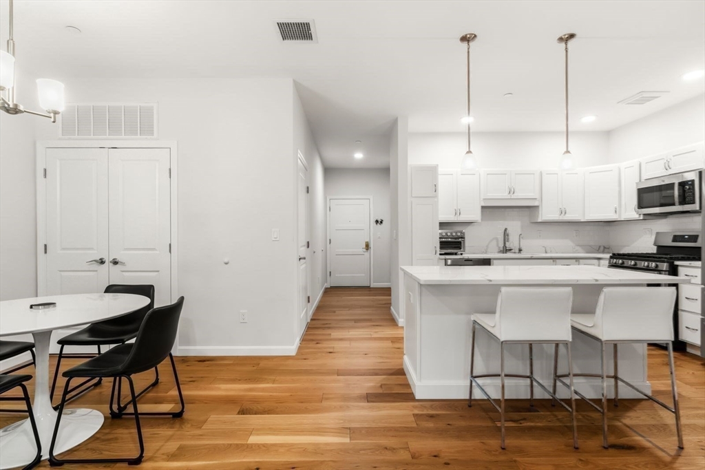 60 Coppersmith Way, Unit 304 Canton, MA 02021 - Photo 3 of 42 a large white kitchen with lots of counter space a sink appliances and cabinets