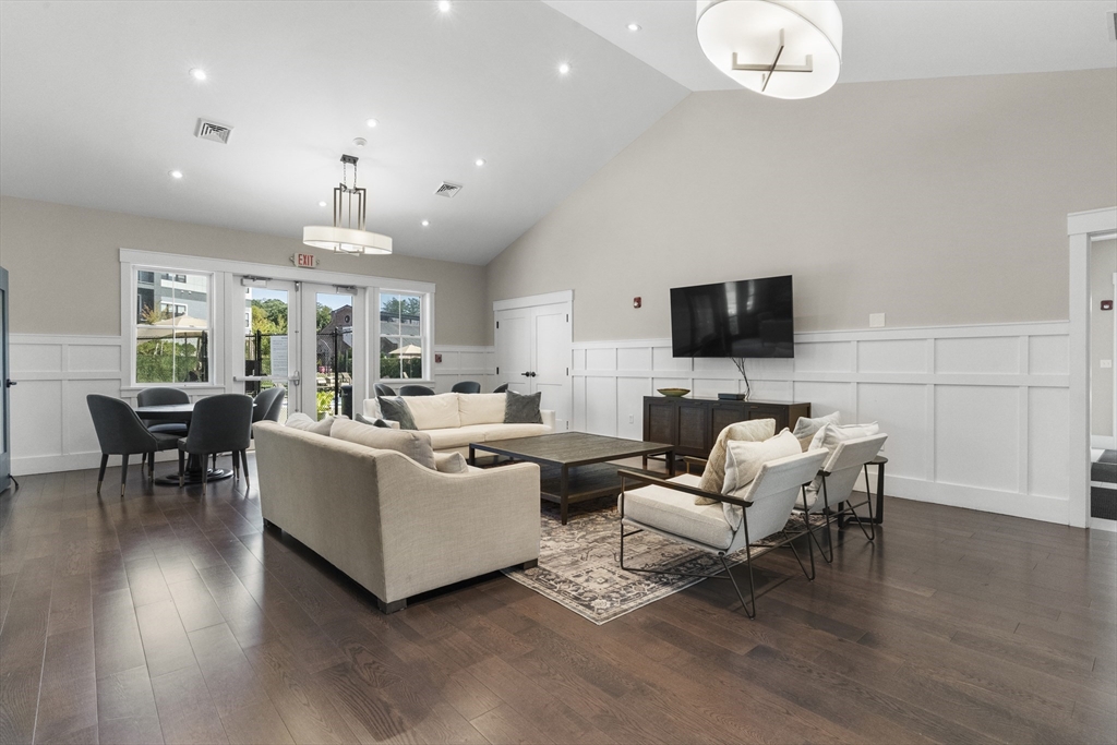 60 Coppersmith Way, Unit 304 Canton, MA 02021 - Photo 35 of 42 a living room with furniture a fireplace and a flat screen tv