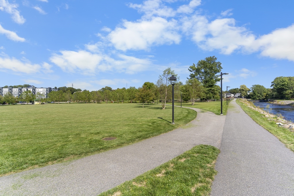 60 Coppersmith Way, Unit 304 Canton, MA 02021 - Photo 40 of 42 a view of a lake with a big yard