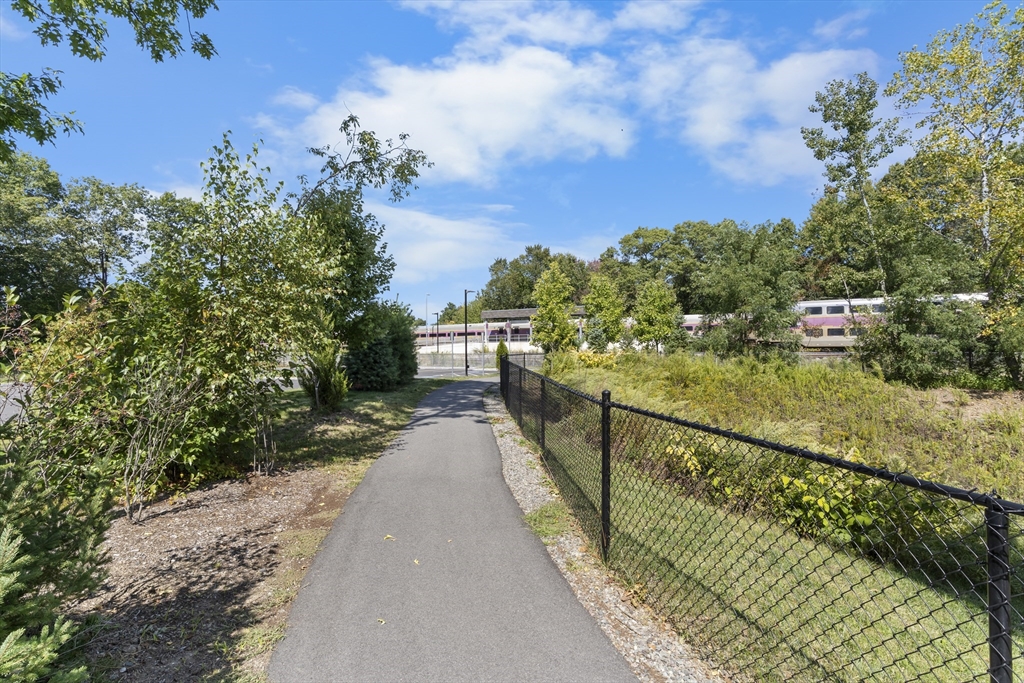 60 Coppersmith Way, Unit 304 Canton, MA 02021 - Photo 42 of 42 a view of a pathway with a wrought fence