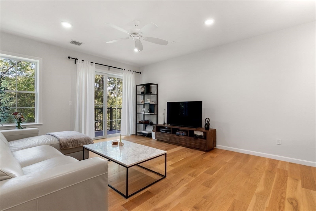 60 Coppersmith Way, Unit 304 Canton, MA 02021 - Photo 8 of 42 a living room with furniture and a flat screen tv
