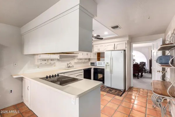 a kitchen with a stove a sink and a refrigerator