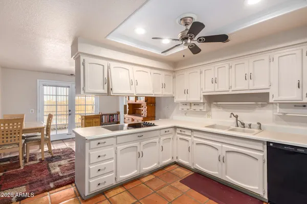a kitchen with a sink window and cabinets