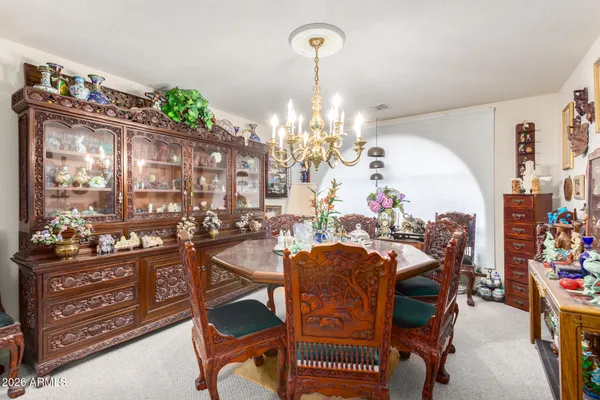 a view of a dining room with furniture and chandelier