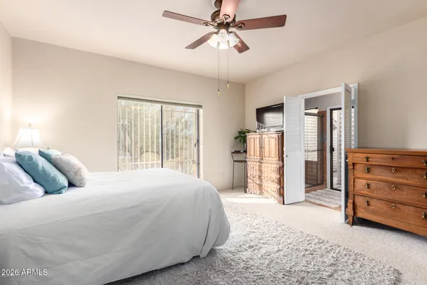 a bed room with a bed and a television