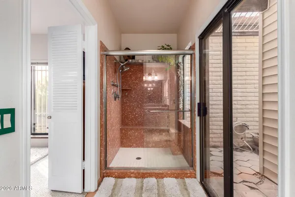 a bathroom with a glass shower door
