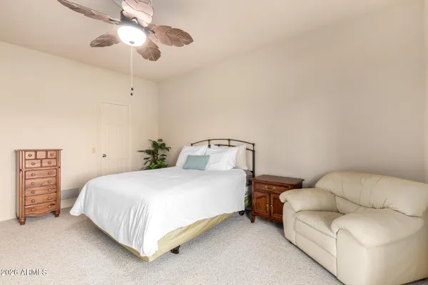 a bedroom with a bed couch and window