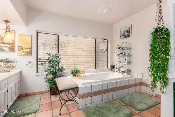 a white bath tub sitting in a bathroom next to a window