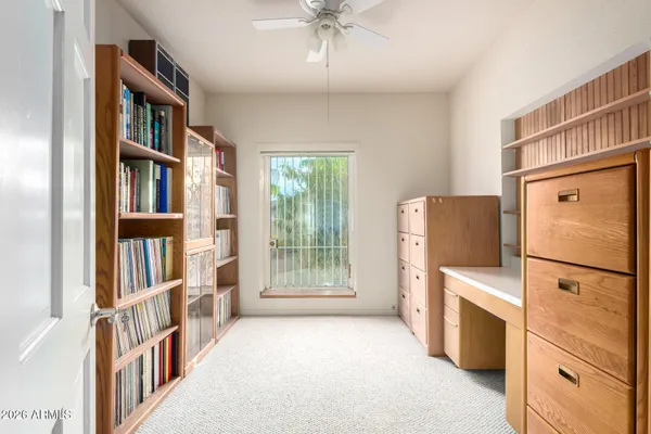 a hallway with cabinets and washer dryer