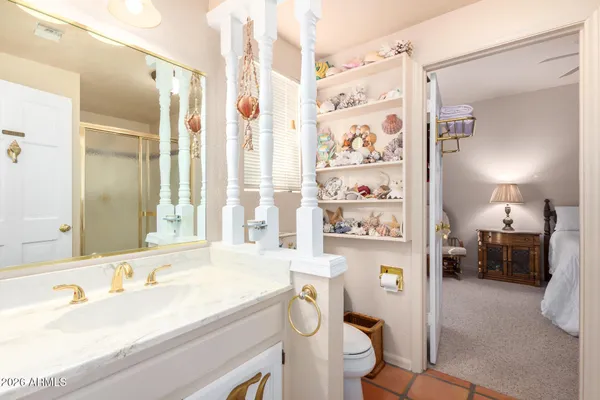 a en suite bathroom with a sink a toilet and a mirror
