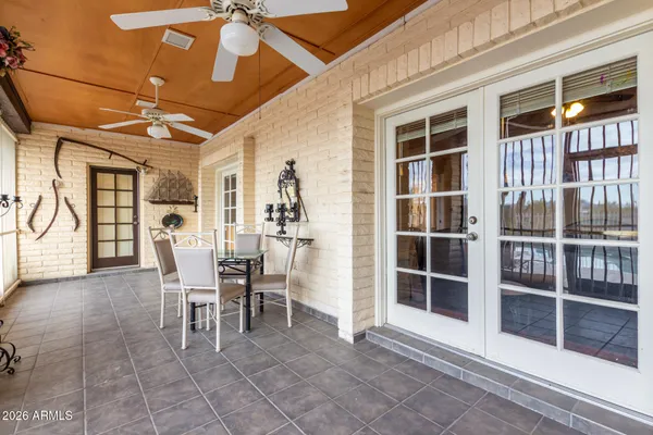 a dining room with furniture and a floor to ceiling window