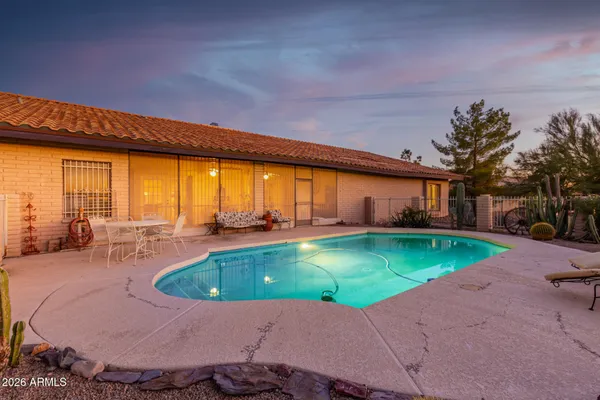 a swimming pool with outdoor seating and yard