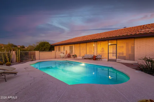 a view of a swimming pool with a yard