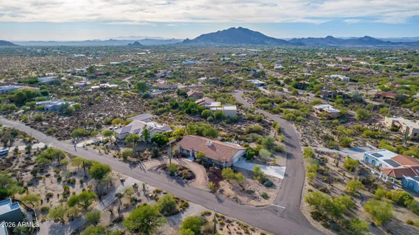 an aerial view of residential houses with outdoor space and street view