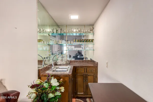 a dining room with furniture and a potted plant
