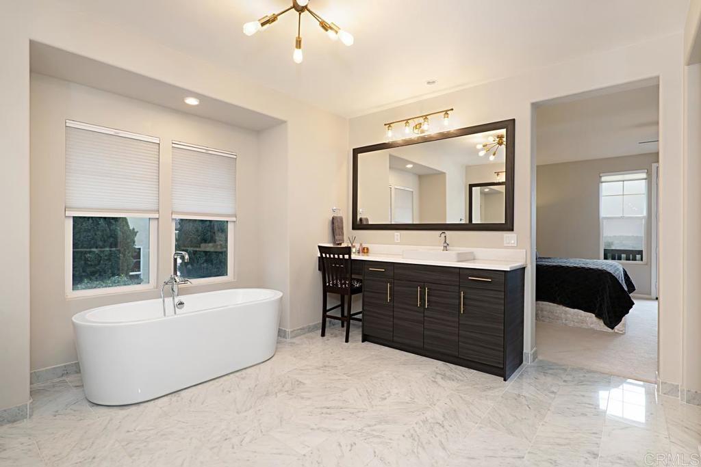 7657 Sitio Algodon Carlsbad, CA 92009 - Photo 28 of 40 a spacious bathroom with a tub double sink and mirror