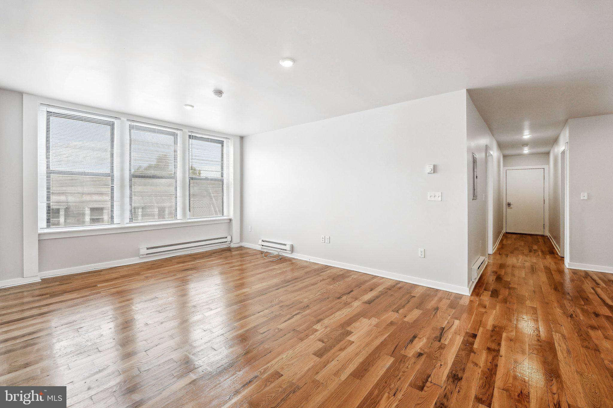 4300 Chestnut Street, Unit 1 Philadelphia, PA 19104 - Photo 11 of 30 a view of empty room with wooden floor and fan